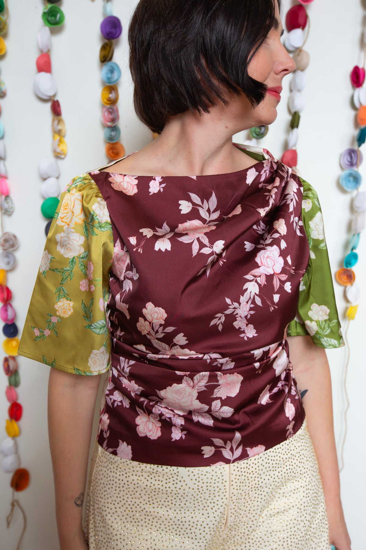 Detail of the Bon Top Rosette mixed-print flutter sleeves in olive green and golden yellow