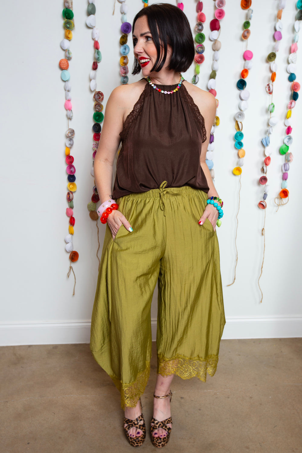 Katie in a Brown halter top with lace details and the new olive and lace balloon pants.