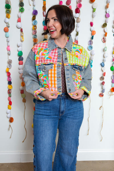 Emma Jean denim jacket buttoned up showing colorful neon embroidered front panels