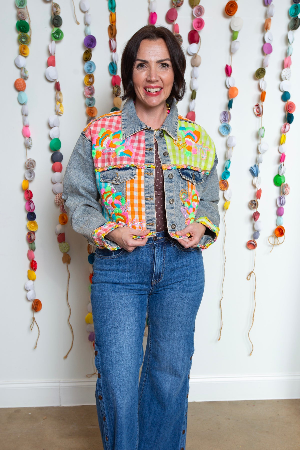 Front view of the Neon Embroidered Emma Jean Jacket styled with flare jeans