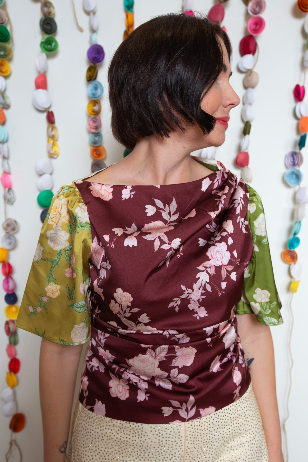 Close-up of the Bon Top draped cowl neckline and burgundy rose print