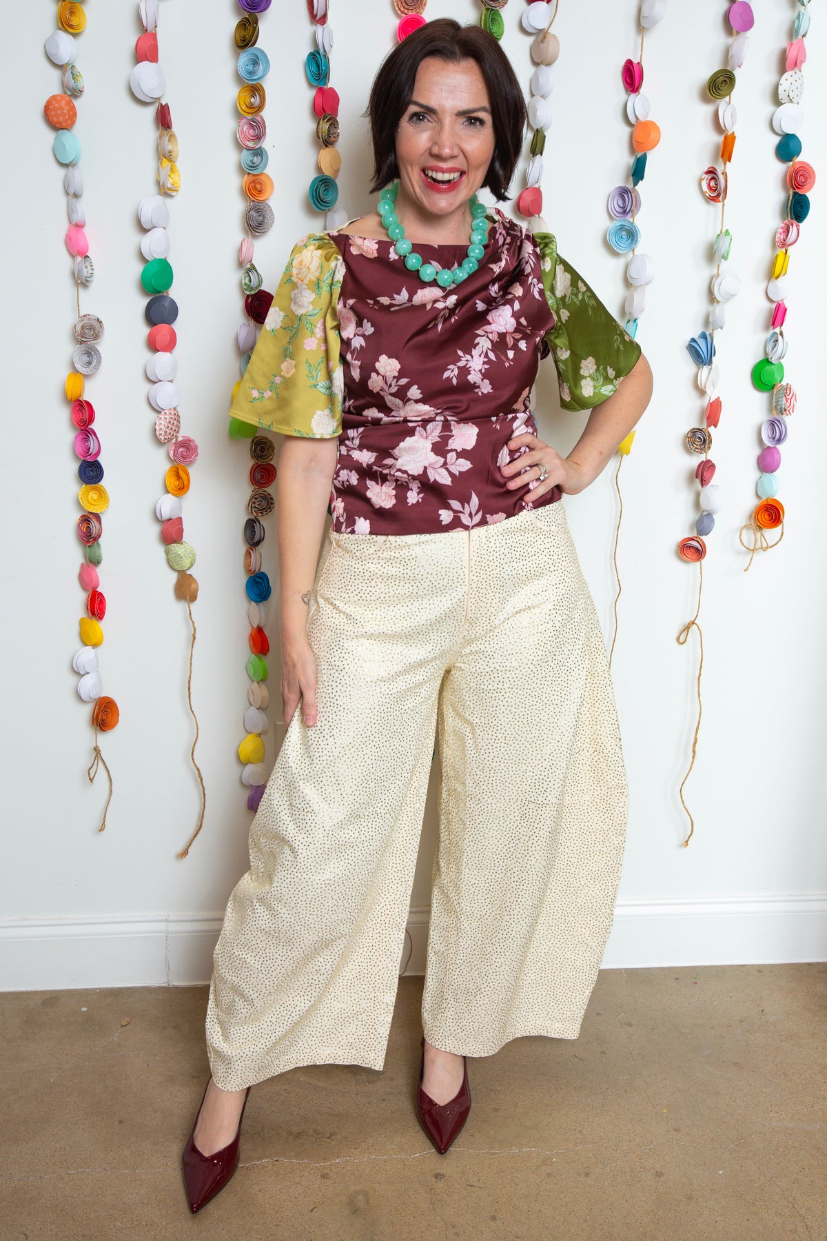 Bon Top Rosette with olive and yellow floral sleeves styled with cream wide-leg pants