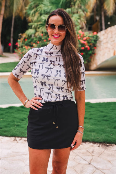 After Dark Black Skort and black and white bow print tee styled poolside