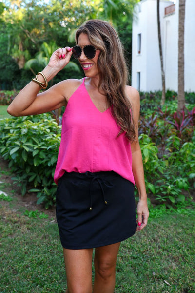 After Dark Black Skort styled with a hot pink halter tank among tropical plants