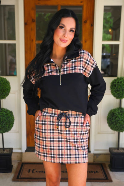 Full front view of the Mia Printed Pullover in Nora Plaid with matching plaid skort on a porch